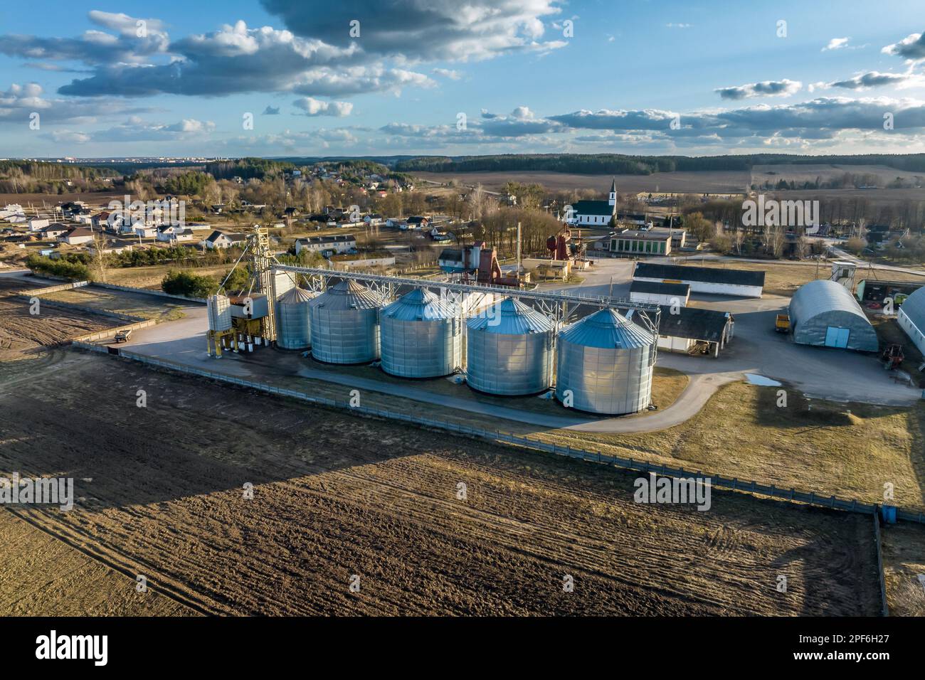 aerial view of agro-industrial complex with silos and grain drying line ...