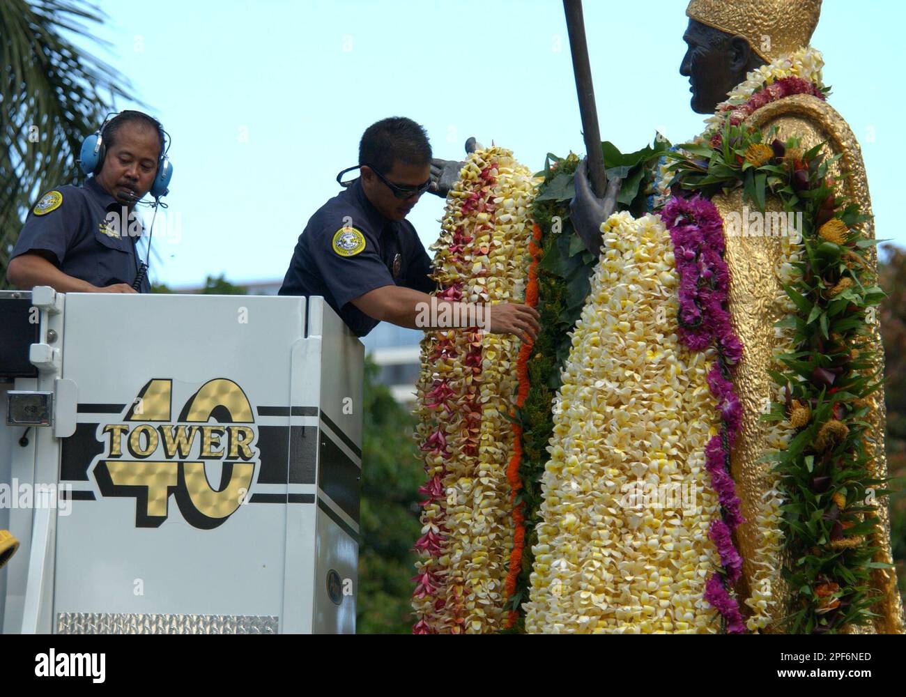 Honolulu Firefighters Robin Desuacedo, left, and Ryan Chong, use a fire