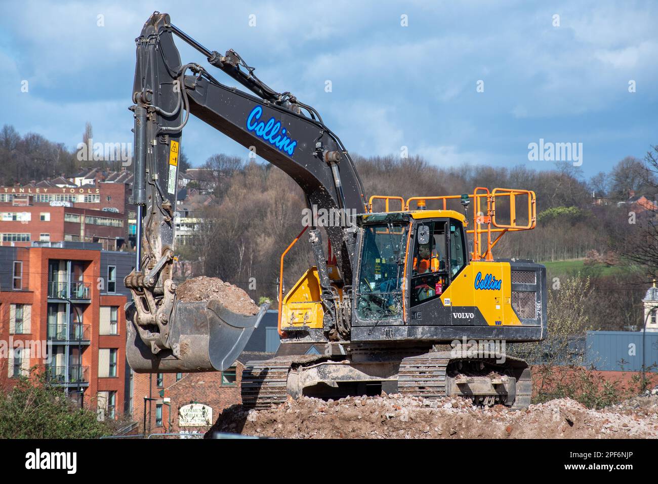 Mechanical shovel on a demolishion/redevelopment site in an urban environment Stock Photo