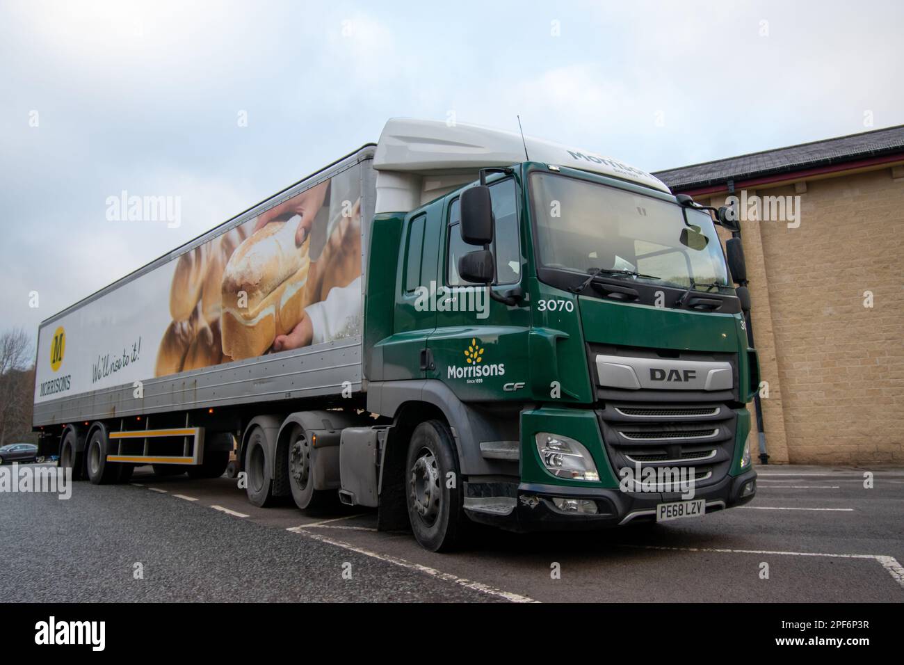 Morrison's DAF CF truck and steel-bodied trailer pulling into a store car park to make a delivery Stock Photo
