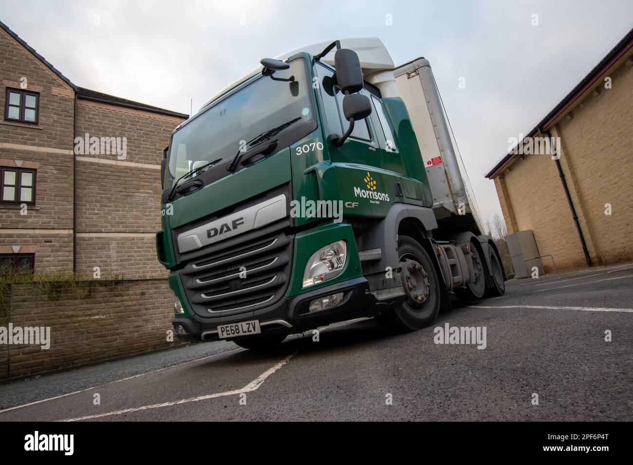 Morrison's DAF CF truck and steel-bodied trailer pulling into a store car park to make a delivery Stock Photo