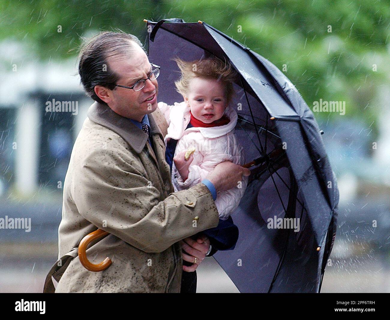 Larry Ehrhardt of Boston protects his daughter Ruth, 2, from the weather while walking in Boston