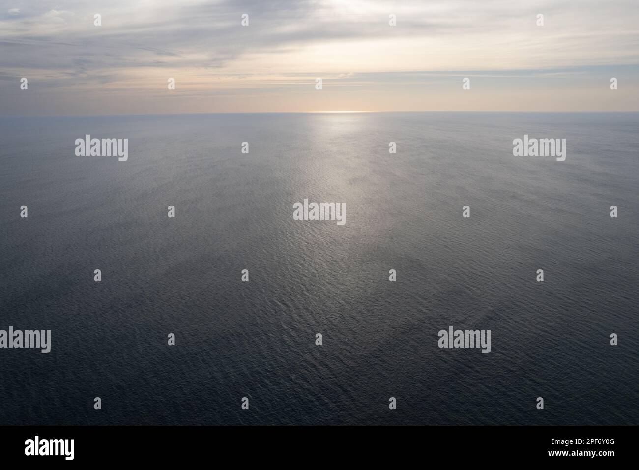 Sunset over calm ocean water seascape aerial drone view Stock Photo