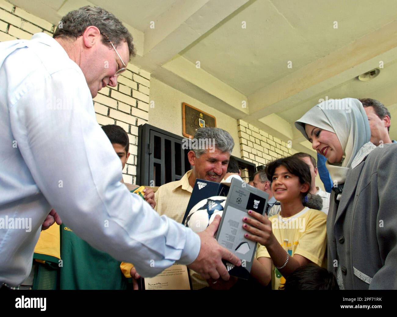 Australian Foreign Minister Alexander Downer, left, gives presents to ...