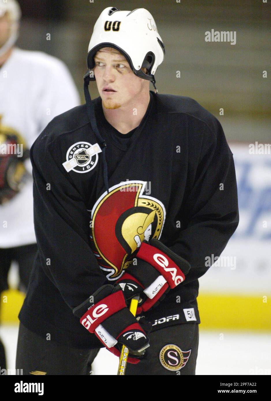 Ottawa Senators Chris Neil wears a helmet backwards as he jokes