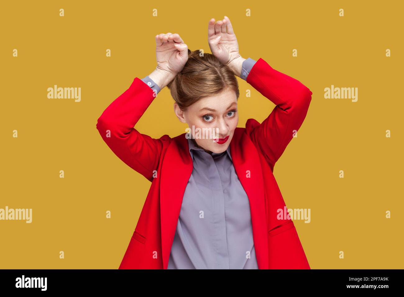 Portrait of funny positive childish woman with red lips standing