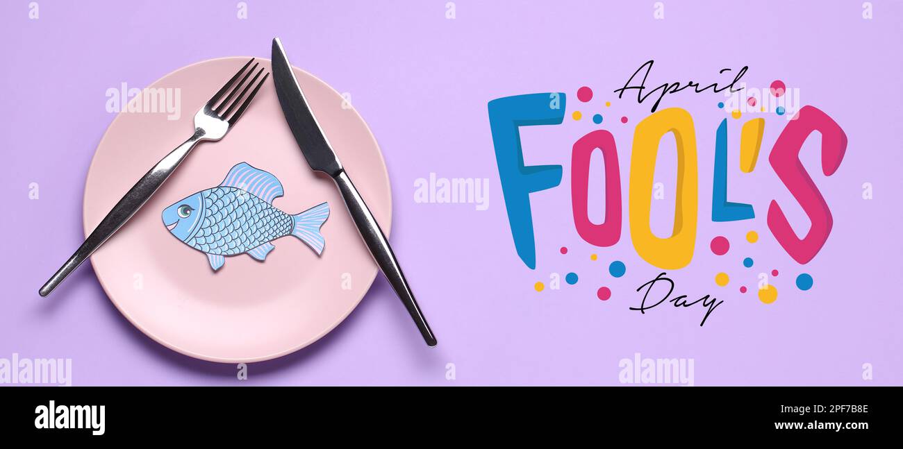 Table setting with paper fish on lilac background. April Fools' Day ...