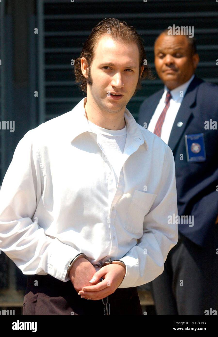 An assistant U.S. Marshal watches in the background as James Justin