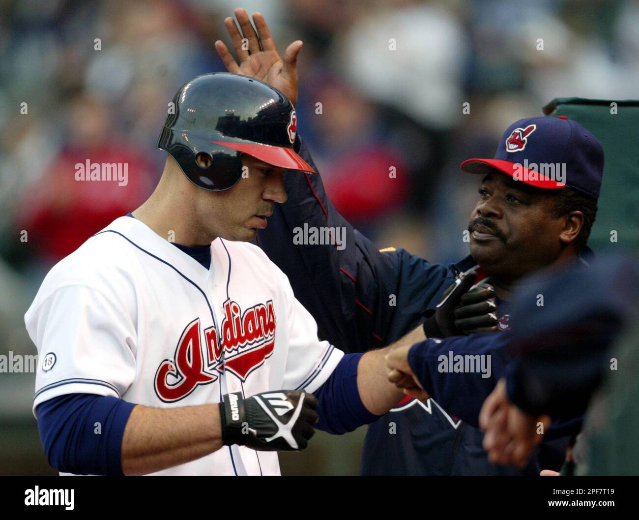 Cleveland Indians hitting coach Eddie Murray, right, pats Indians