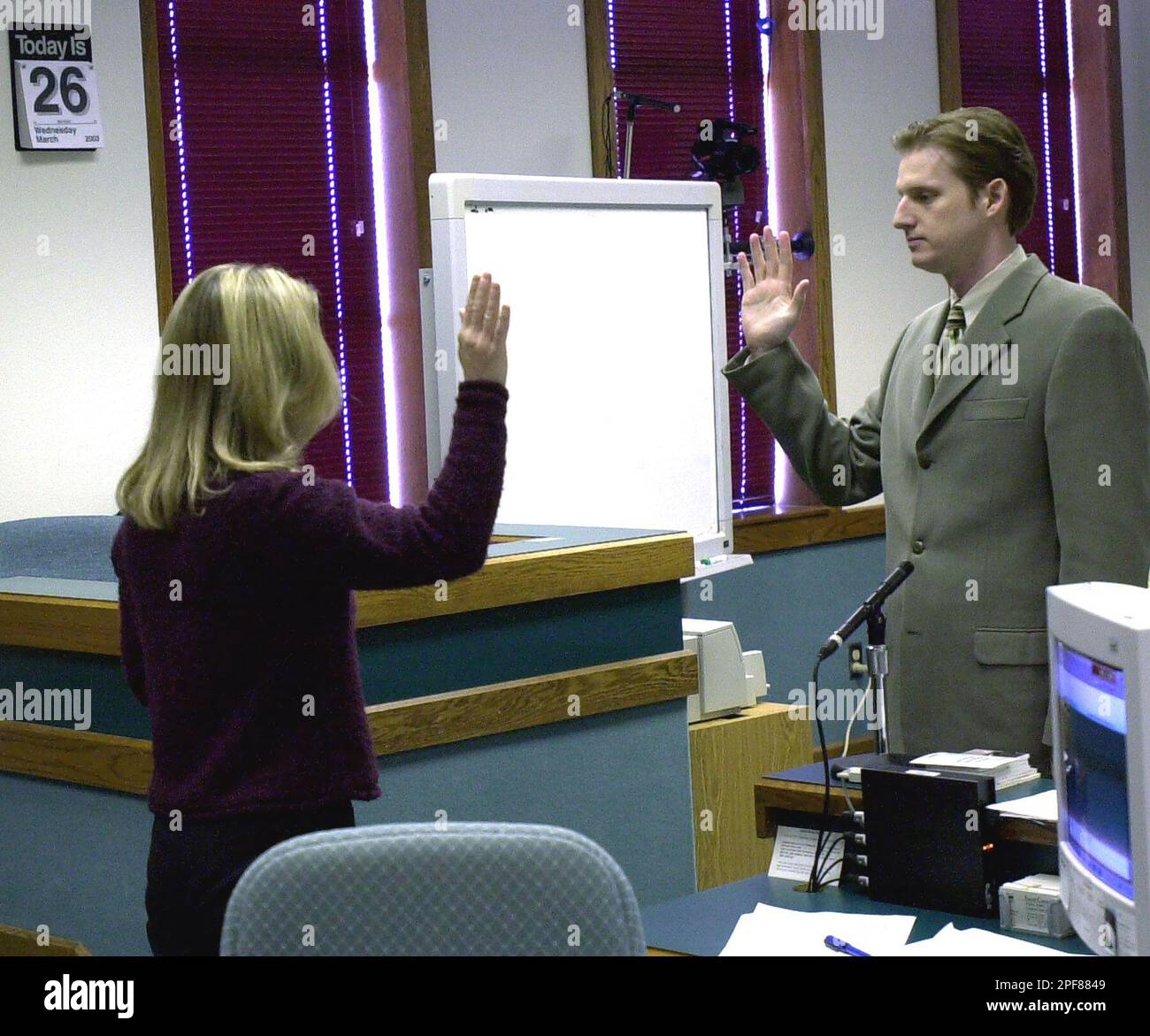 Christian Longo, right, is sworn in before taking the stand in his own
