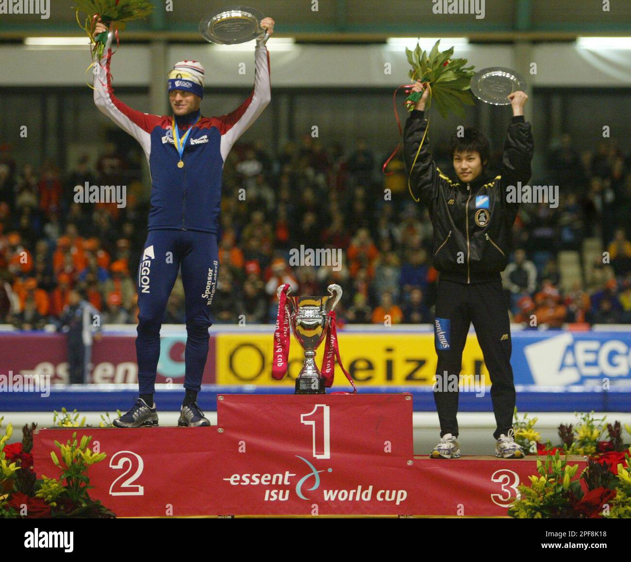 Japan's Joji Kato, right, third place, and Holland's Erben Wennemars,  second place, stand on the winners podium next to the empty overall winner  stand for the 500 meters World Cup at the