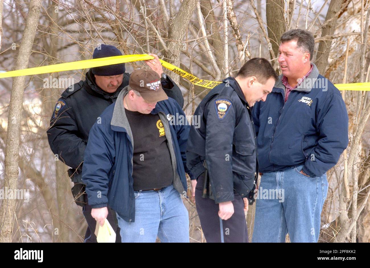 Fremont Police officials from left, Brian Woods, Tim Woolf, Roger Oddo and  Jim White return from a Sandusky River enbankment where the body of  11-year-old Chanel Barnett was found in Fremont, Ohio