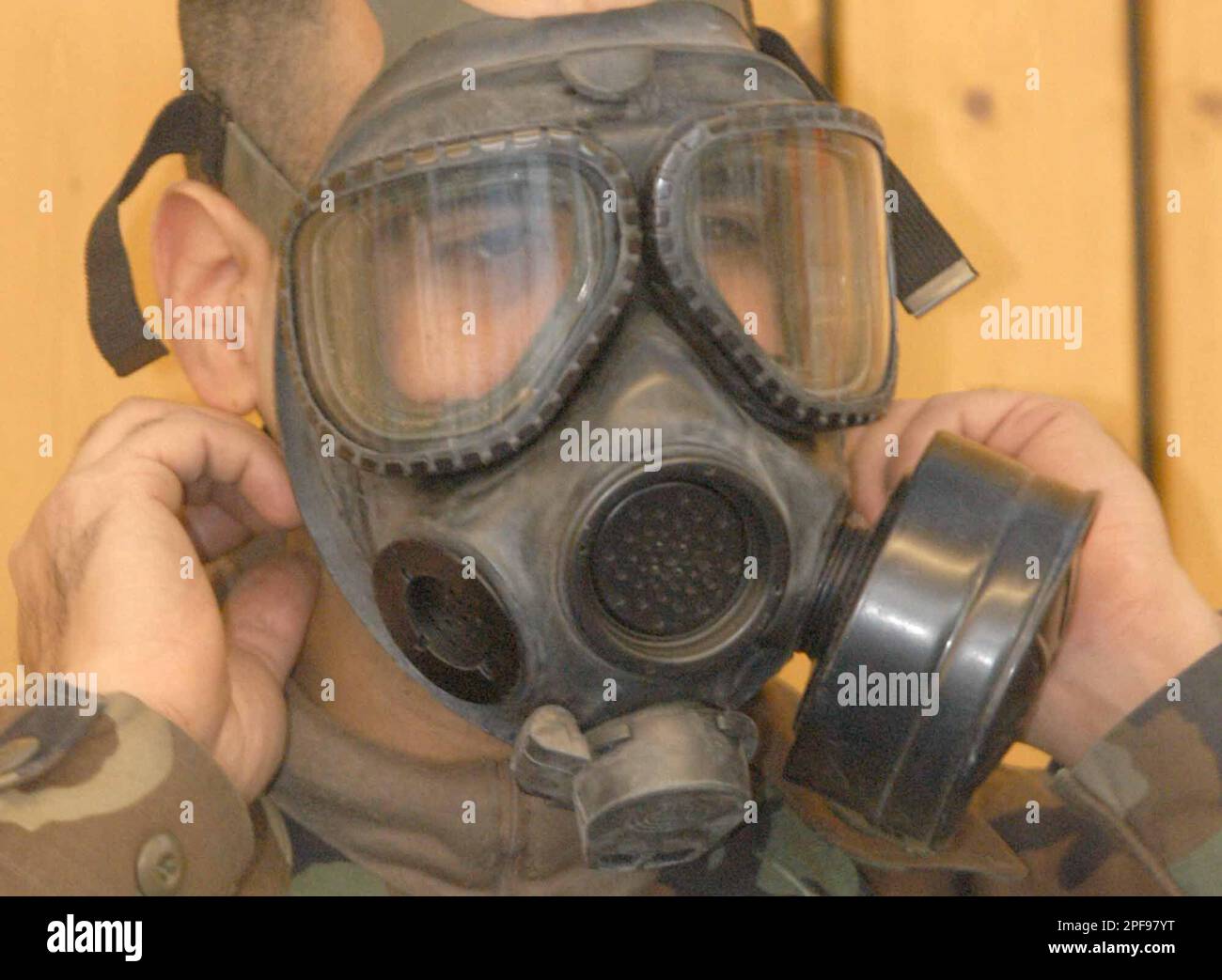 Sgt. Kirtan Stoute, from New York, NY a gasmask at the Barracks in Wuerzburg, Germany, on Friday, Jan. 31, 2003. The U.S. soldiers are equipment in preparation deployment