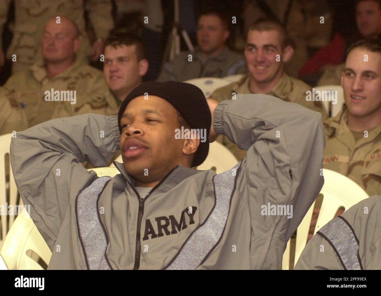 An unidentified US soldier watches Super Bowl XXXVII between Tampa