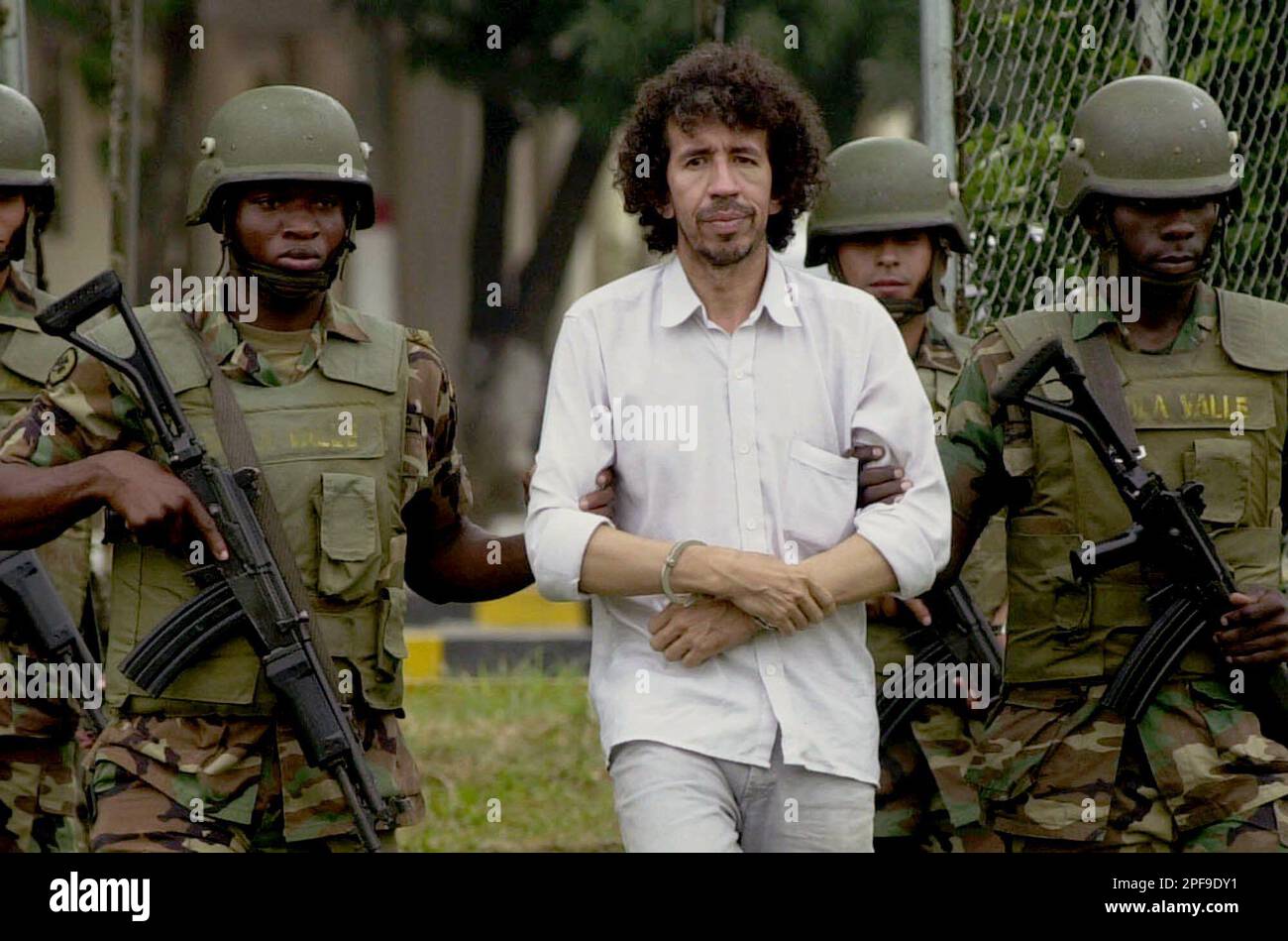 Colombian soldiers escort alleged rebel of the Revolutionary Armed Forces  of Colombia, or FARC, Jorge Alberto Diaz in Cali, Colombia, Tuesday, Jan.  14, 2003. Diaz was arrested in Cali for allegedly taking