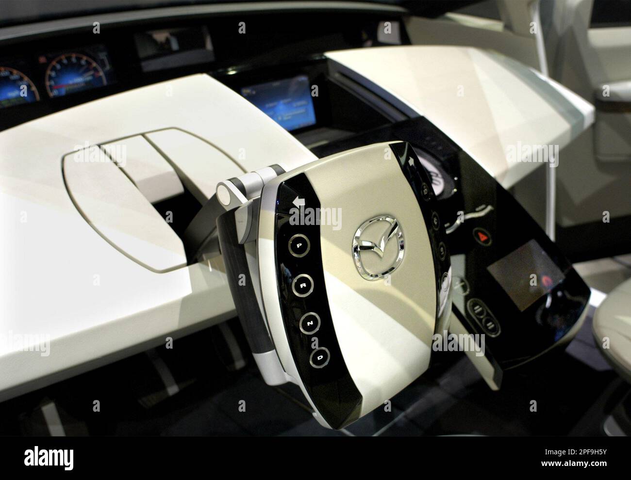 The interior and steering column of the Mazda sixseat concept vehicle