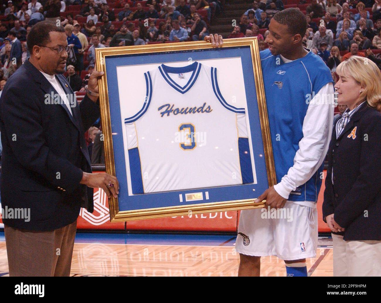 Tracy McGrady, second from right, has his high school basketball jersey  retired in a ceremony during halftime of the Orlando Magic's game against  the New Jersey Nets in Orlando, Fla., Saturday, Jan.