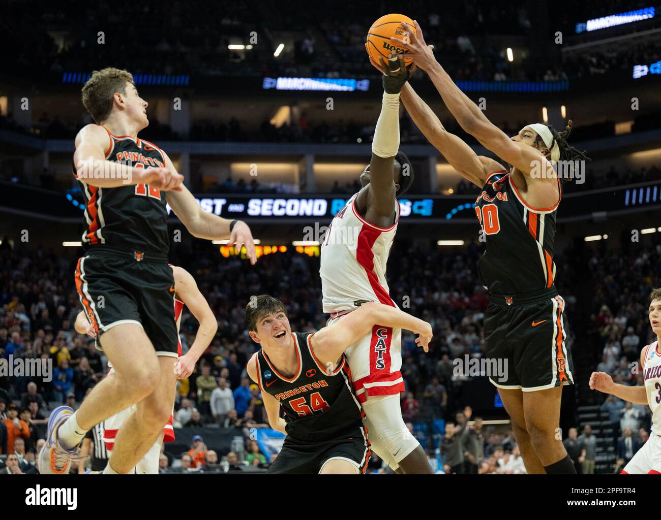 Sacramento, CA, USA. 16th Mar, 2023. Princeton Tigers forward Tosan Evbuomwan (20) grabs ball from Arizona Wildcats center Oumar Ballo (11) assisted by Princeton Tigers forward Zach Martini (54), during a game in the NCAA Tournament at Golden 1 Center in Sacramento, Thursday, March 16, 2023. (Credit Image: © Paul Kitagaki Jr./ZUMA Press Wire) EDITORIAL USAGE ONLY! Not for Commercial USAGE! Stock Photo