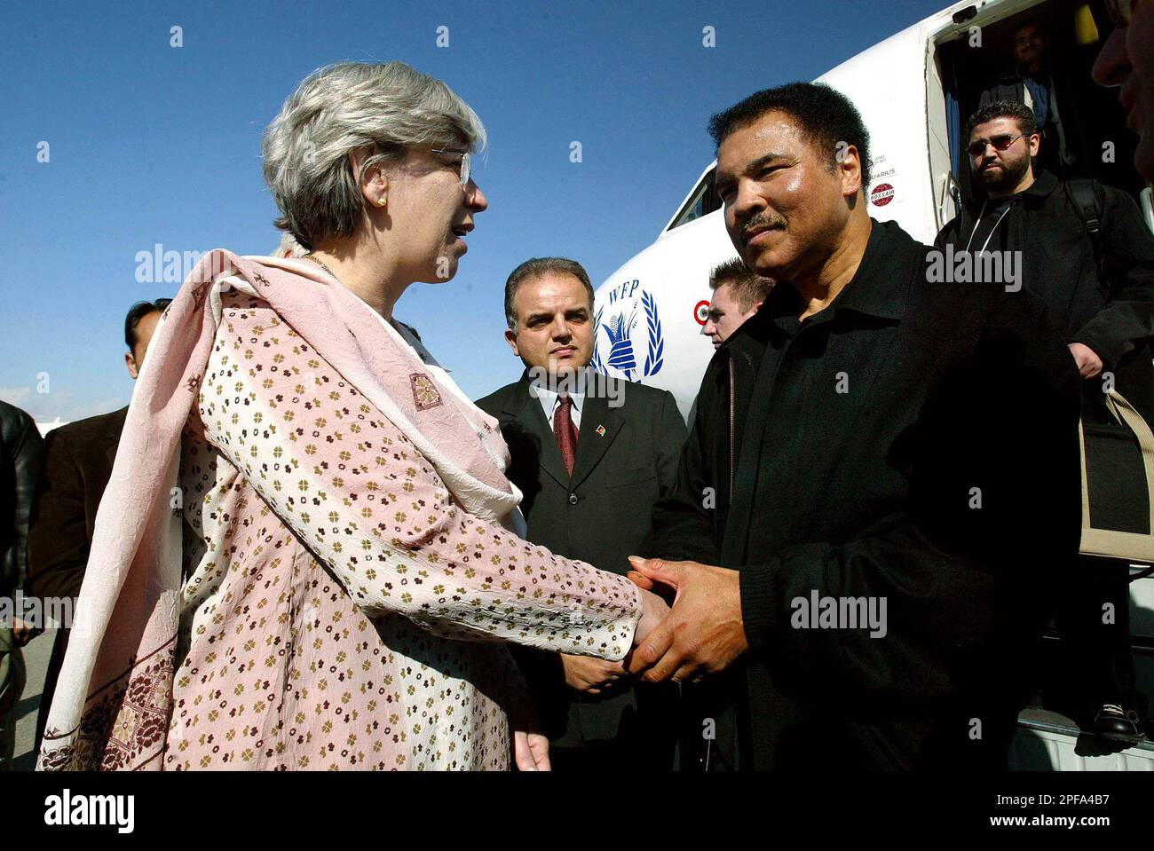 American boxing legend Muhammad Ali, right, is greeted by