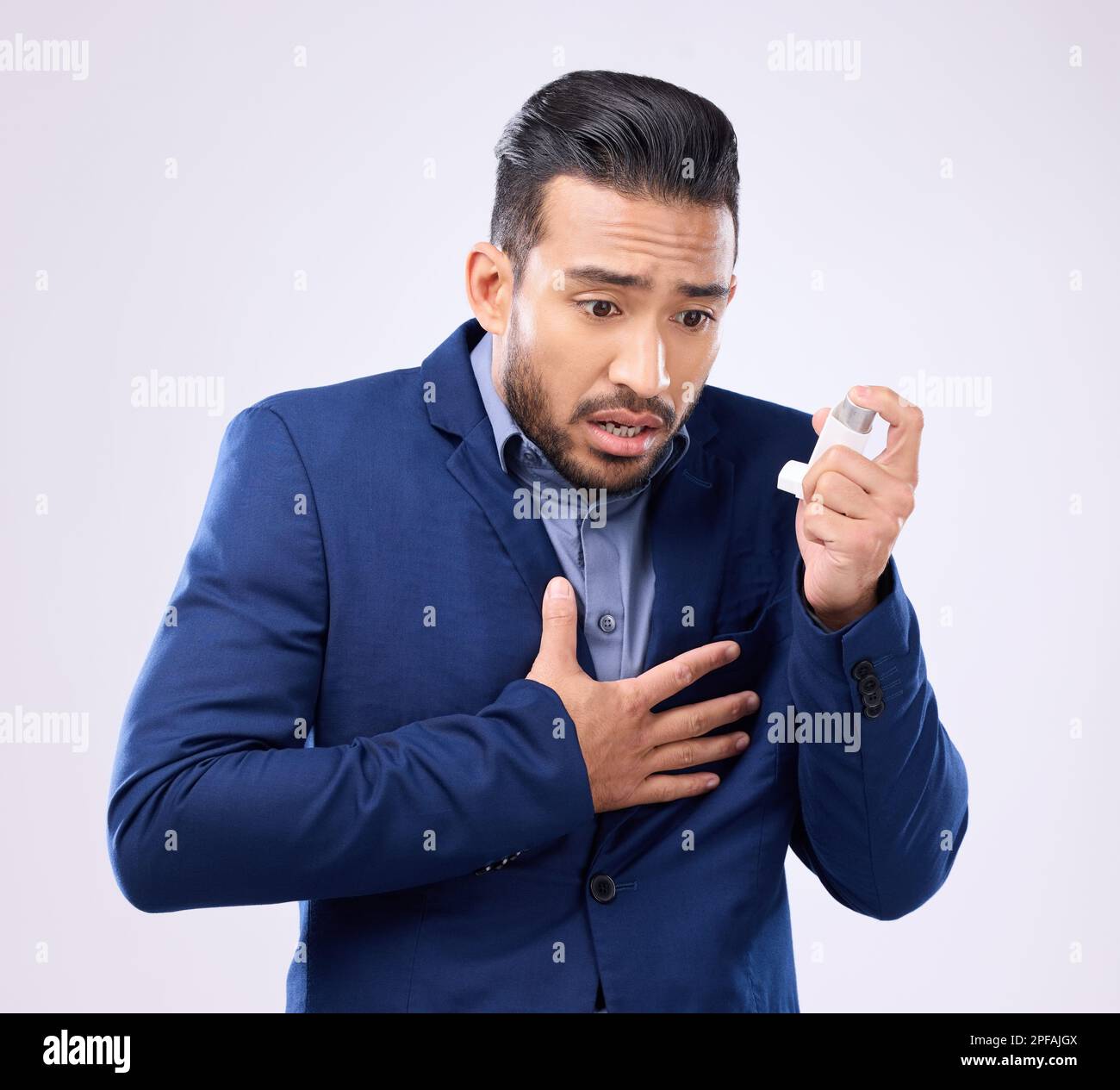 Asthma pump, business man and breathe in studio, medical health and
