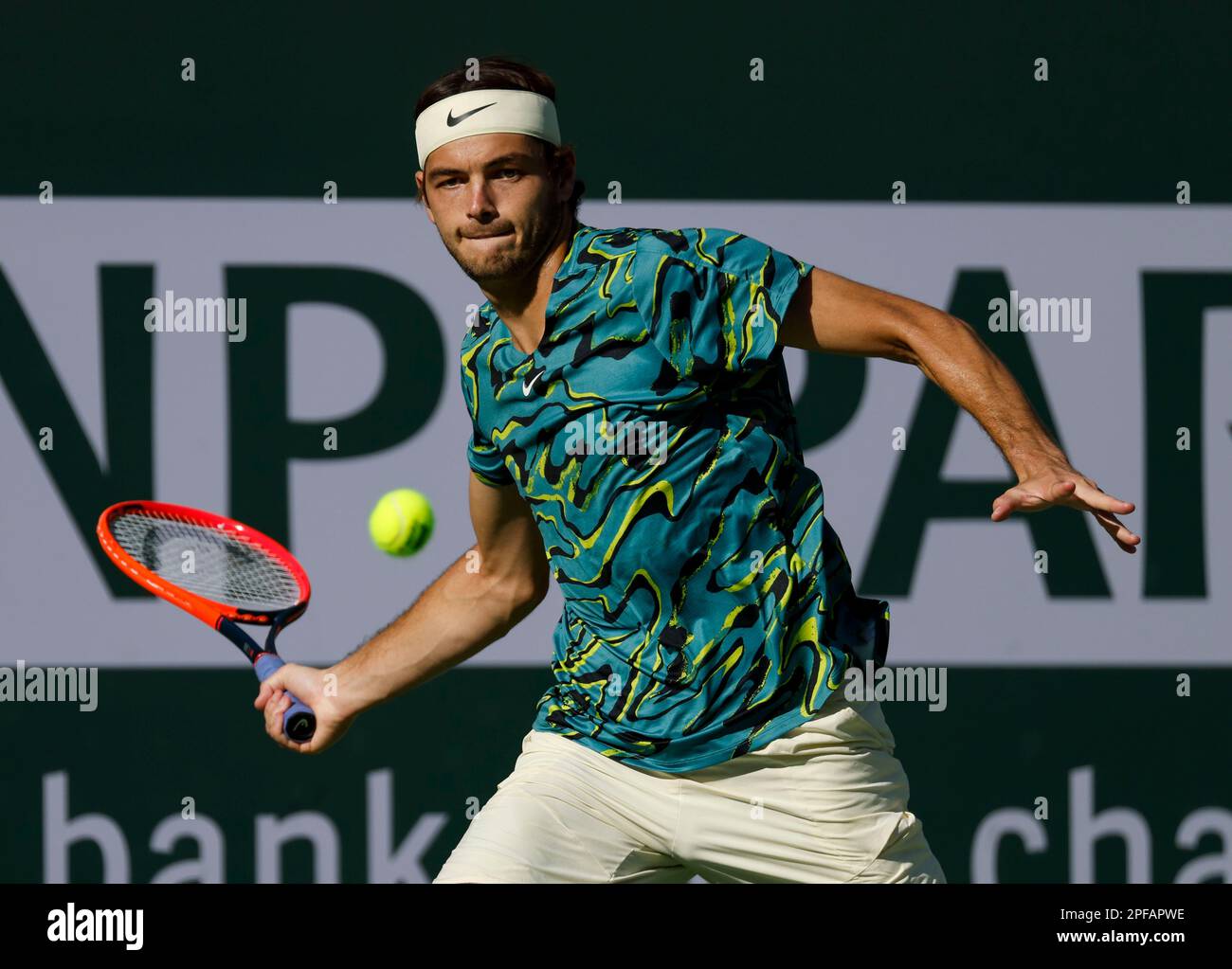 March 16, 2023 Taylor Fritz returns a shot against Jannik Sinner of ...