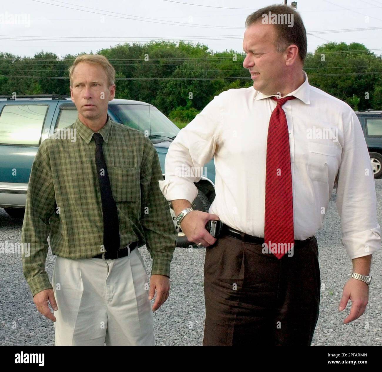 Alvin Latham, left, and his attorney Peter Barbee wait outside the