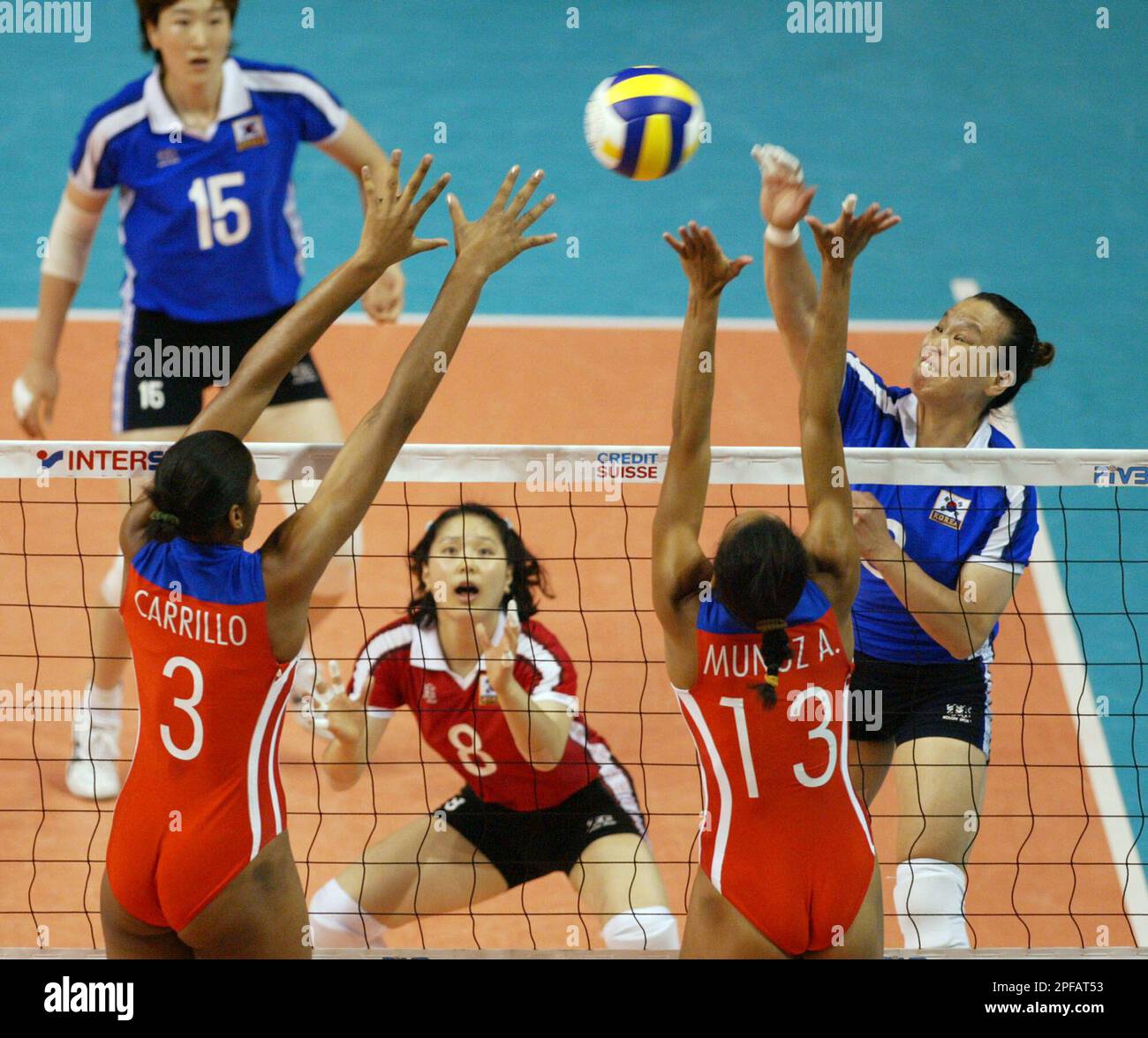 South Korea's Kwang-Hee Choi, right, smashes the ball towards Cuba's Nancy  Carrilo De La Paz, left, and Anniara Munoz Carrazana during their final  match for placing 5th or 6th at the Women's