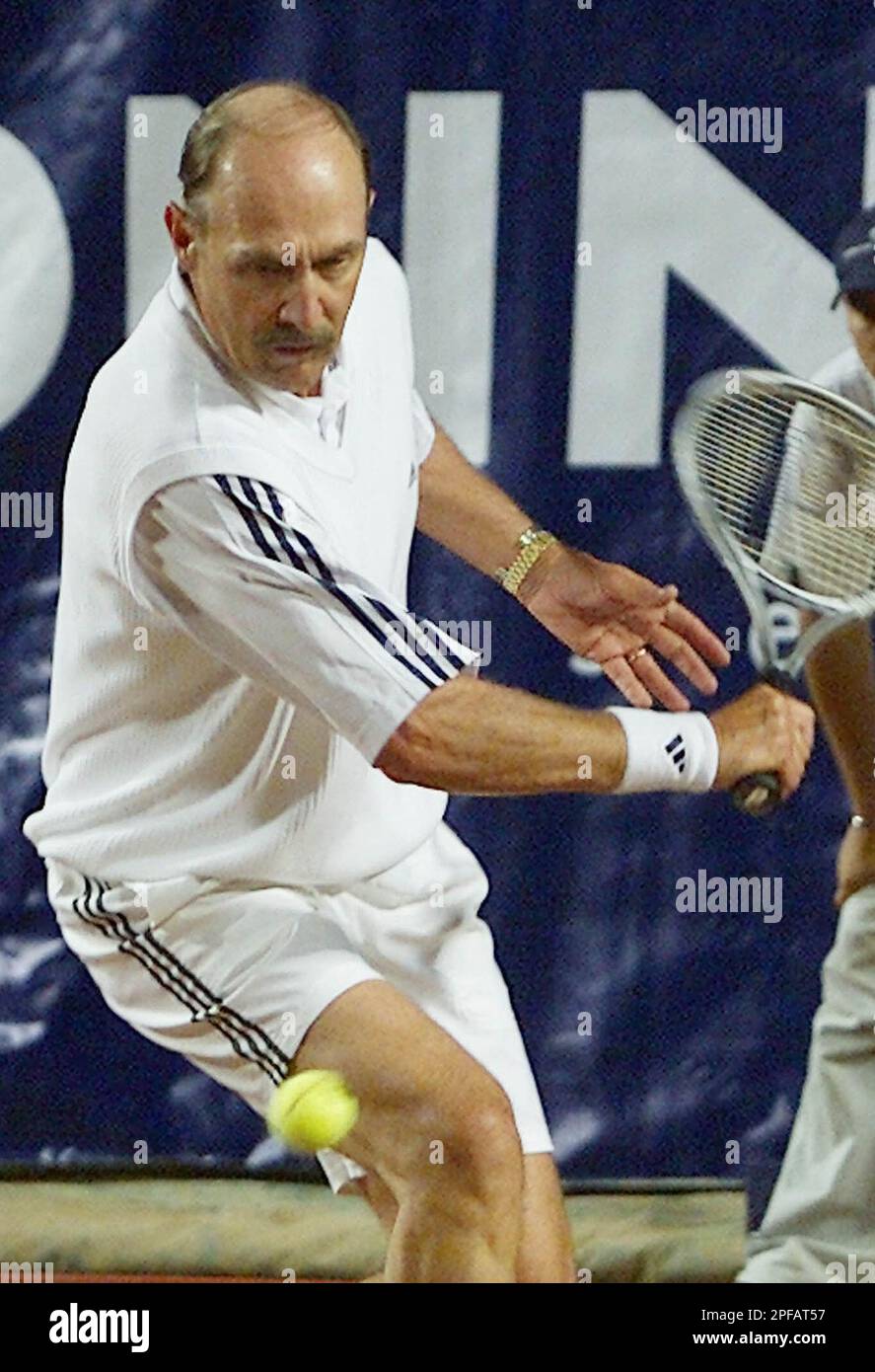 US former tennis star player Stan Smith returns a ball to Romania's Ilie  Nastase in Bucharest, Romania, Saturday, Sept. 14, 2002 during a  demonstration match in the same formation as in the