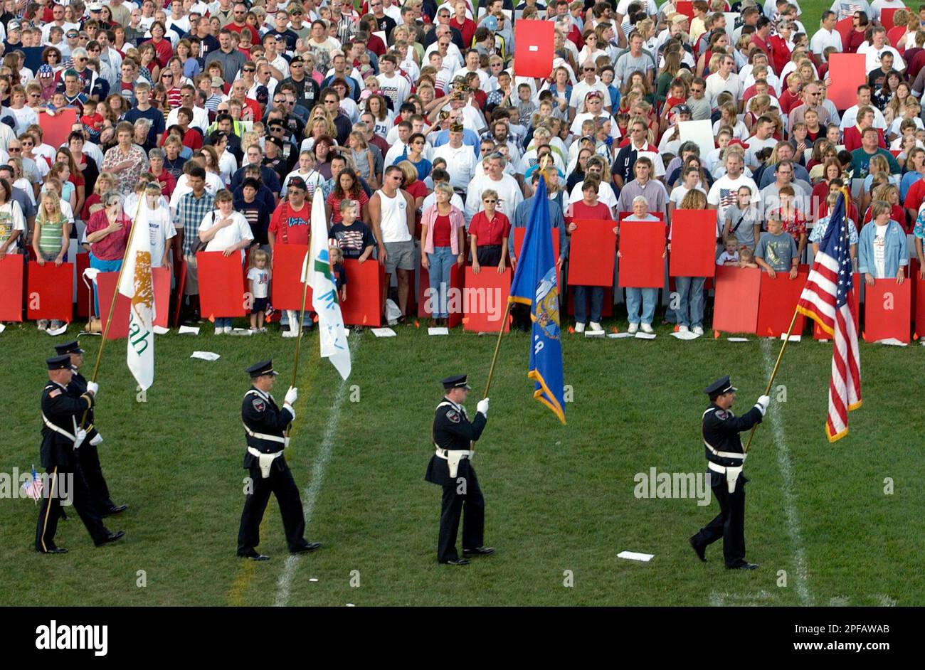 Firefighters representing local departments carry flags at the start of