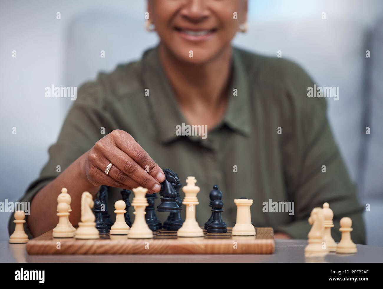 Woman playing chess thinking of next move Stock Photo - Alamy