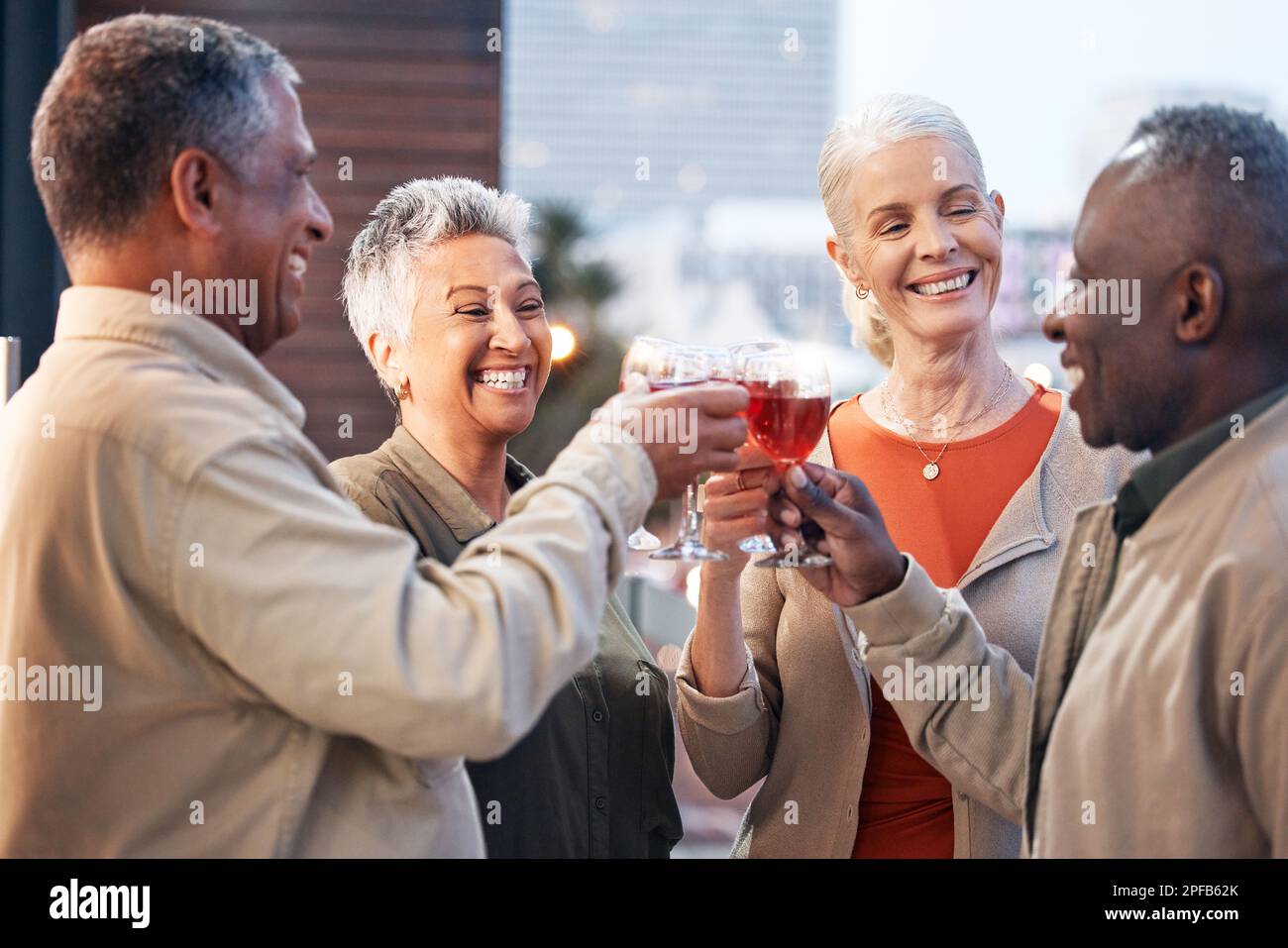 Friends, mature people with wine and retirement party, cheers and glasses with happiness, celebration and fun outdoor. Senior, men and women with Stock Photo