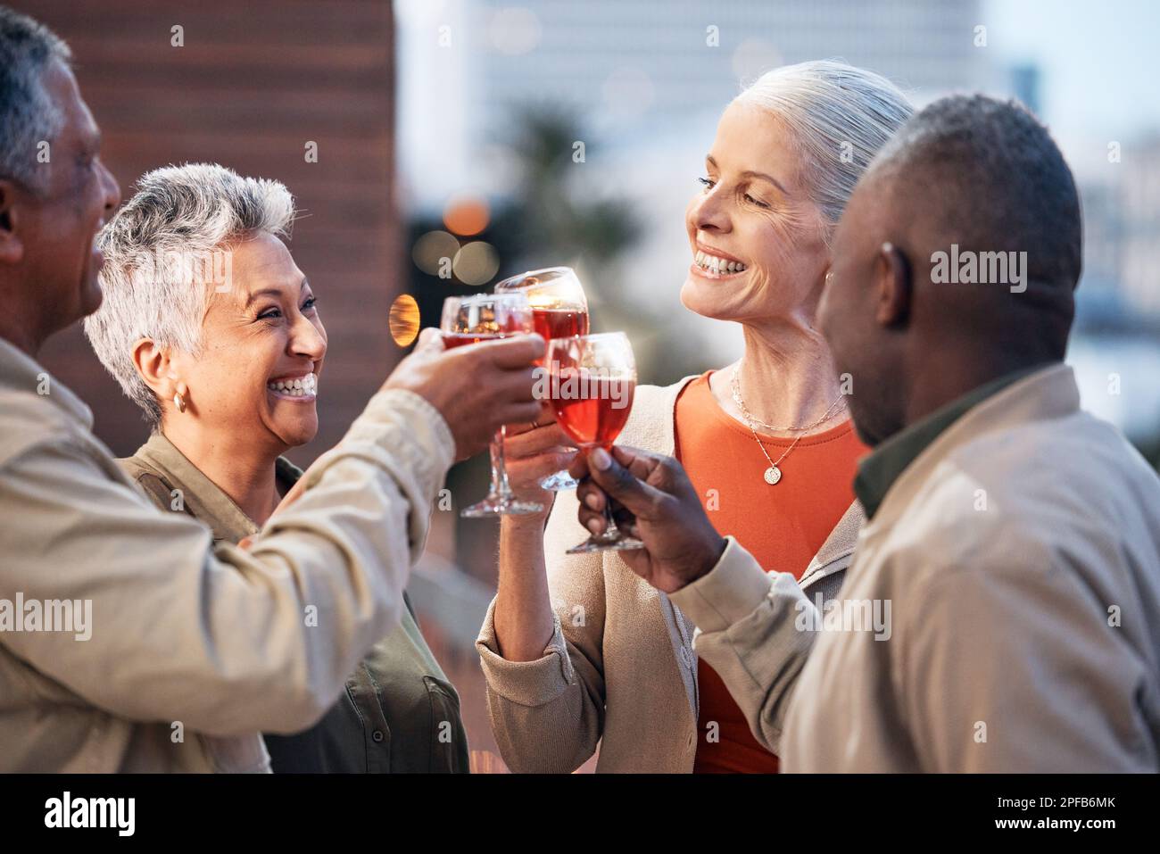 Friends, senior people with wine and retirement party, cheers and glasses with happiness, celebration and fun outdoor. Mature, men and women with Stock Photo