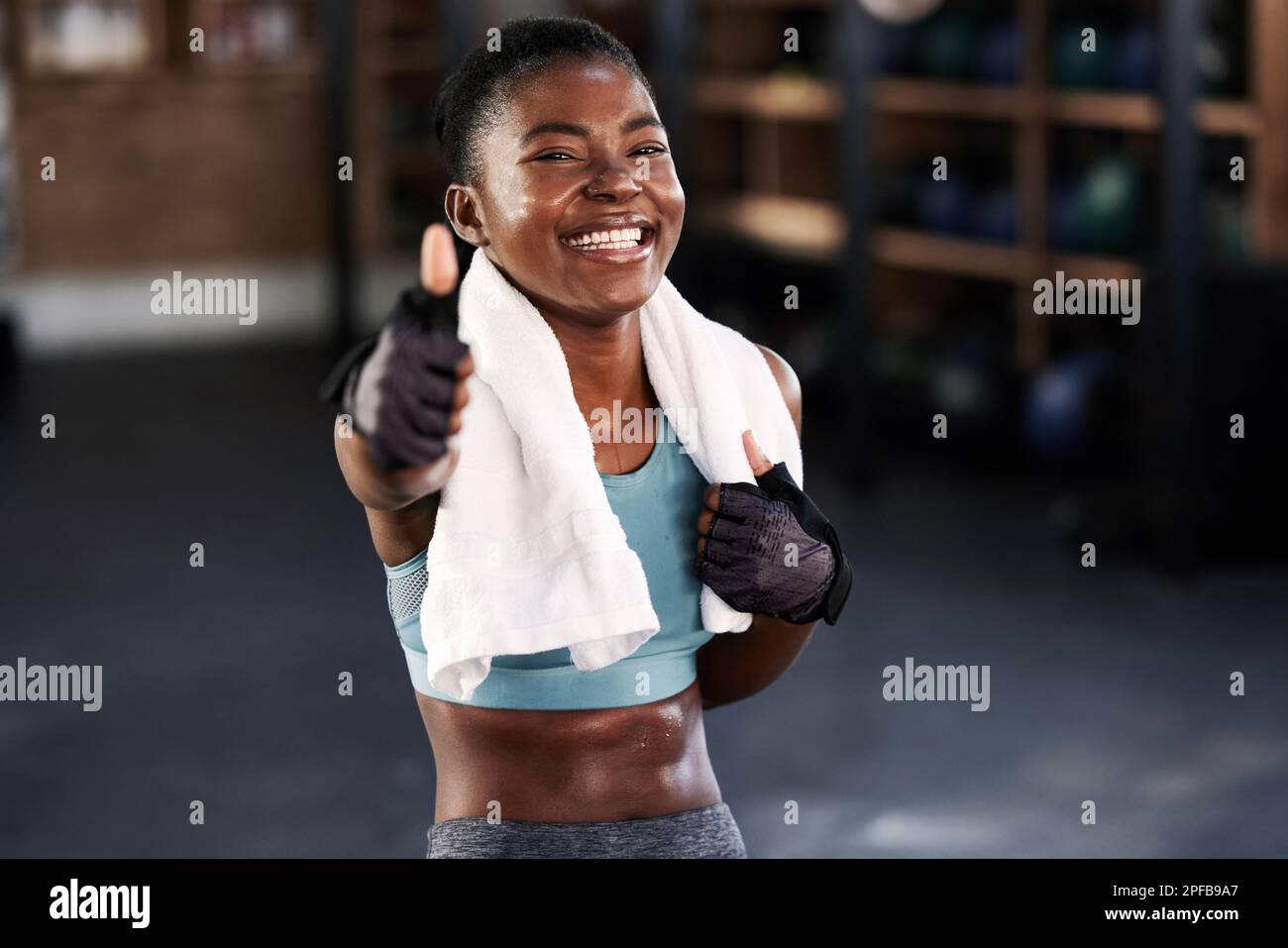 Always be a work in progress. a fit young woman showing thumbs up while