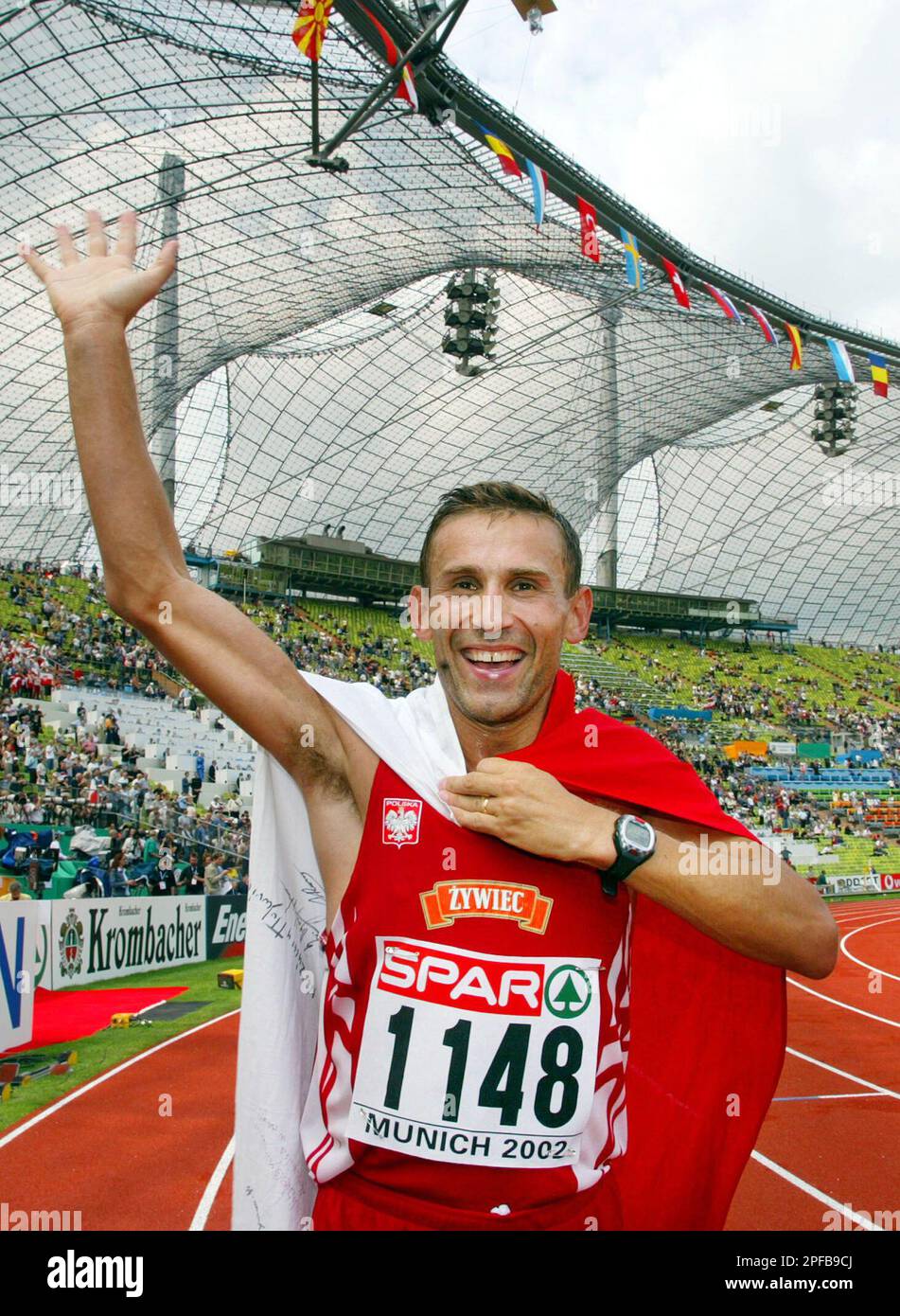 Poland's Robert Korzeniowski celebrates on his victory lap after winning the gold medal in the Men's 50k walk in a new world record time of 3:36:39 hours during the European Athletics Championships in Munich, Germany, Thursday Aug. 8, 2002. (AP Photo/Thomas Kienzle) Stock Photo