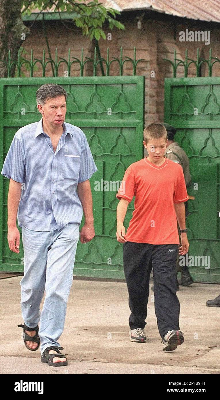 https://c8.alamy.com/comp/2PFB9HT/an-unidentified-man-with-a-child-leaves-the-murree-christian-school-in-murree-60-kilometers-35-miles-north-on-islamabad-on-tuesday-august-6-2002-the-five-unidentified-gunmen-stormed-the-gates-of-the-school-in-the-popular-mountain-resort-monday-killing-at-least-six-people-and-wounding-two-others-ap-phototariq-aziz-2PFB9HT.jpg