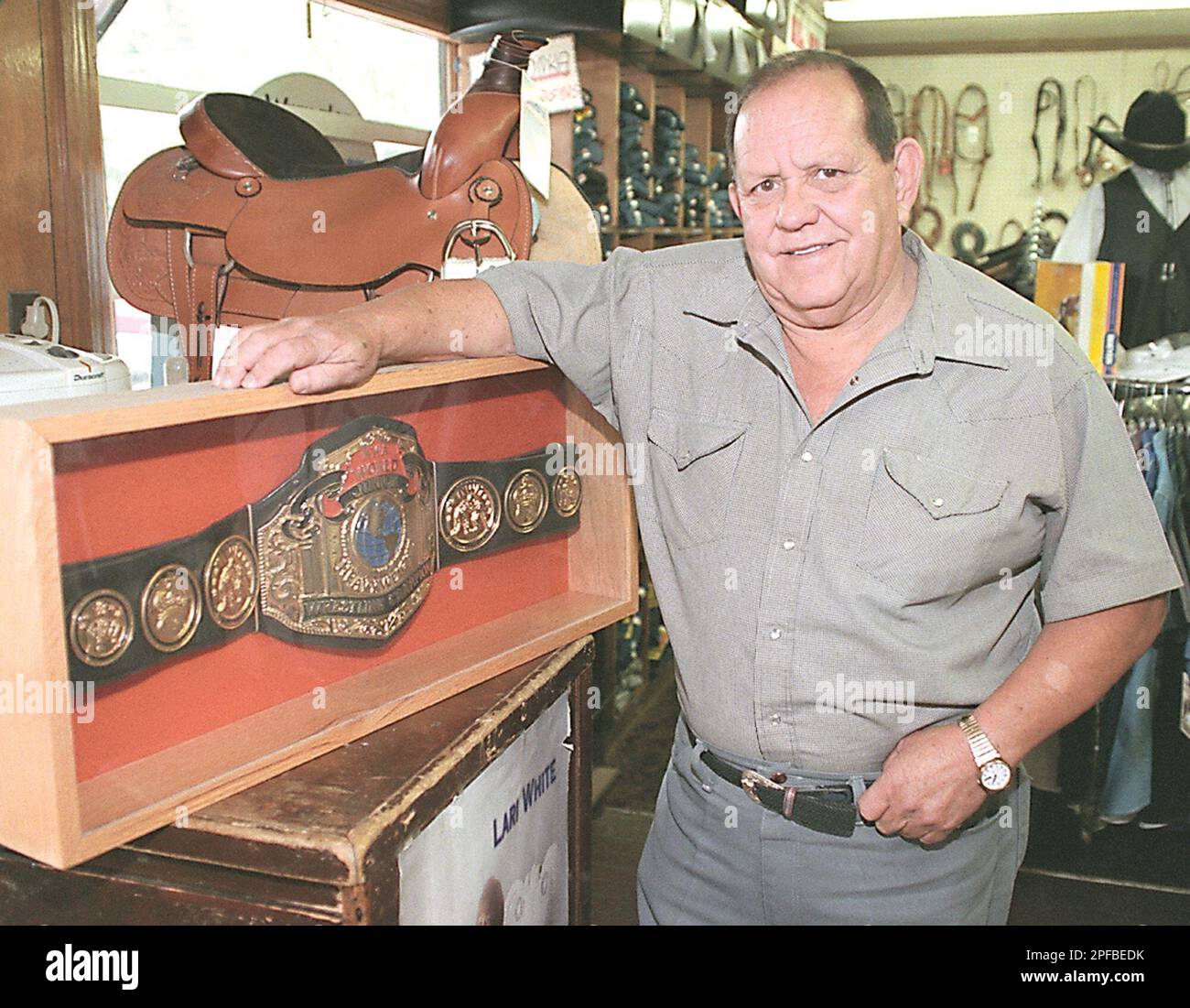 Former pro wrestler Nelson Royal poses with his title belt in this 1999  file photo at his western wear store in Mooresville, N.C. Royal died  Sunday, Feb. 3, 2002 while visiting a