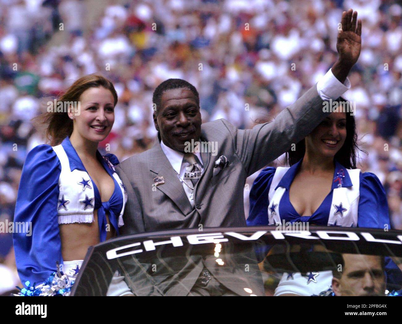 Former Dallas Cowboys wide receiver Bob Hayes waves to the fans as he