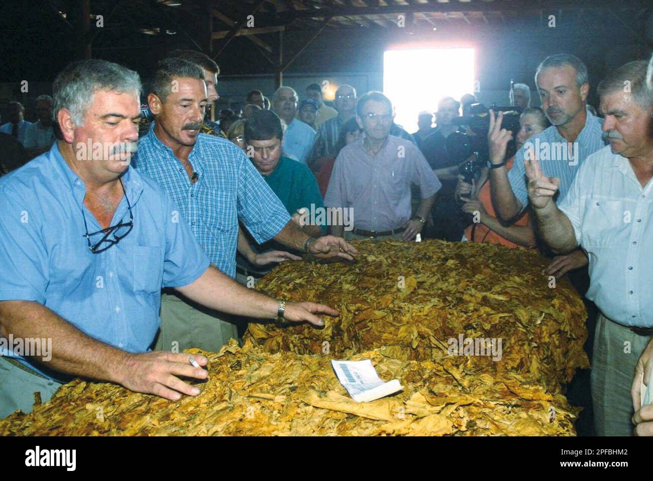 tobacco warehouse wilson nc Teddy Lamm, left, manager of the cooperative Growers Warehouse in Wilson,  N.C., leads an auction during opening day of the season for the tobacco  market, in this July 25, 2001 photo. The