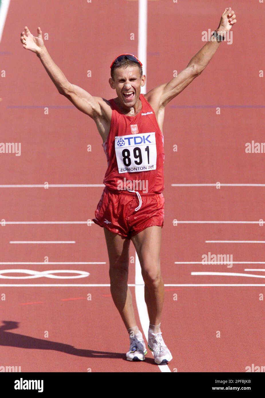 Poland's Robert Korzeniowski celebrates after crossing the finish line to win the men's 50 kilometers walk at the World Track and Field Championships in Edmonton, Alberta, Saturday August 11, 2001. (AP Photo/CP, Kevin Frayer) Stock Photo