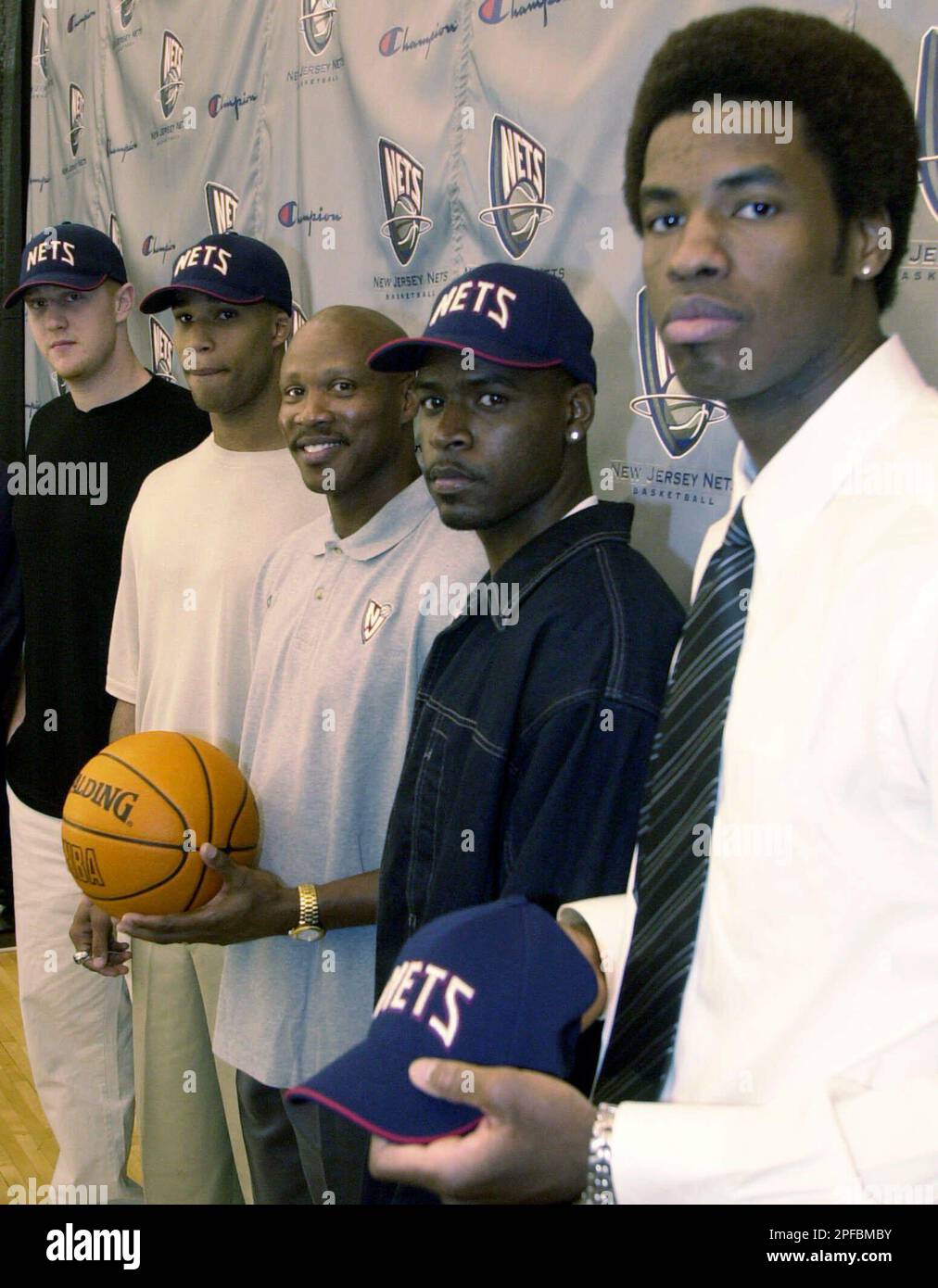 New draft picks for the New Jersey Nets pose with Nets head coach Byron  Scott, third from left, during a news conference at the Nets training  center in East Rutherford, N.J., Monday,