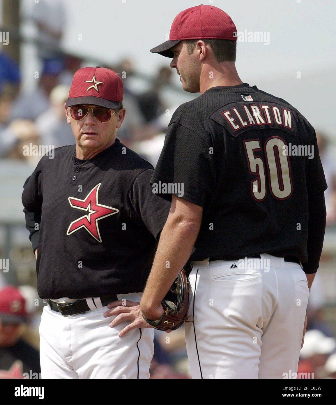 Houston Astros pitching coach Burt Hooten, left, talks to pitcher