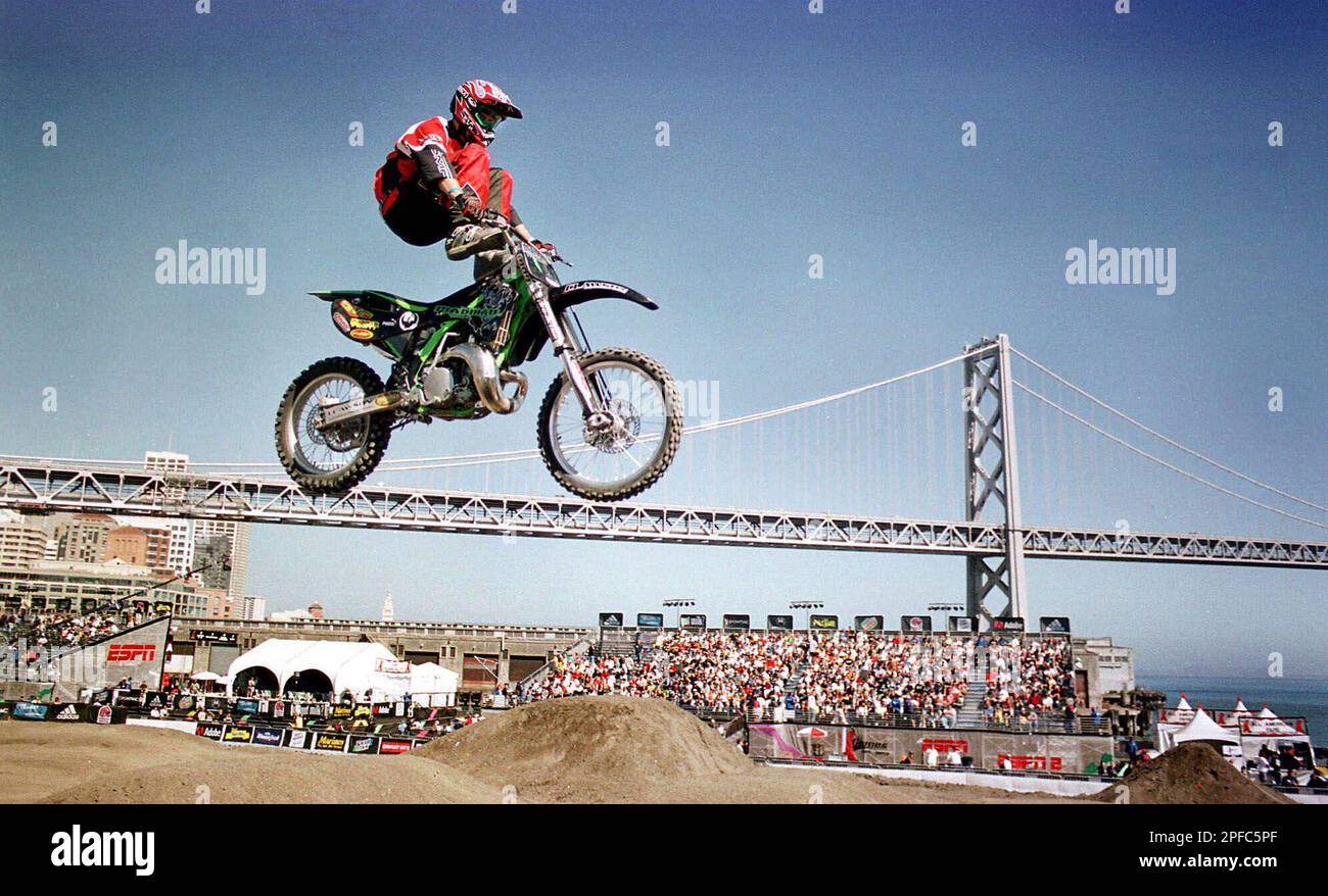 Jeremy Carter puts his feet on his motorcycles handlebars during the Motocross Freestyle competition as thousands of spectators watch at the ESPN X Games on piers 30 and 32 in San Francisco,