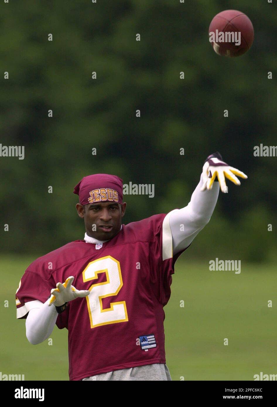 Washington Redskins cornerback Deion Sanders throws the ball around