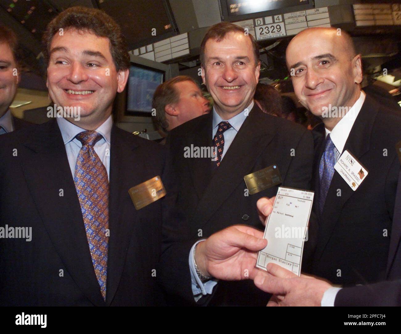 Jonathan Bloomer, left, group chief executive, and Roger Hern, center,  chairman of Great Britain's Prudential PLC, join New York Stock Exchange  Chairman Richard Grasso in holding the order for the first 100