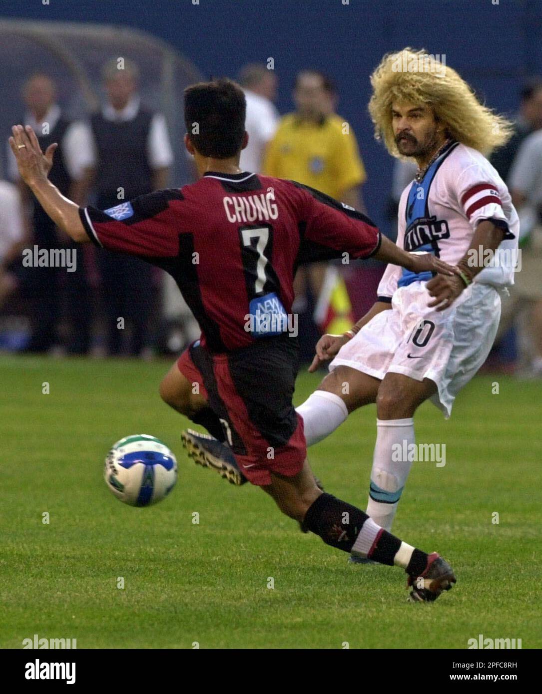 Tampa Bay Mutiny midfielder Carlos Valderrama, right, passes the ball past  New York/New Jersey MetroStars midfielder Mark Chung during the first half  Friday, June 9, 2000, at Giants Stadium in East Rutherford,