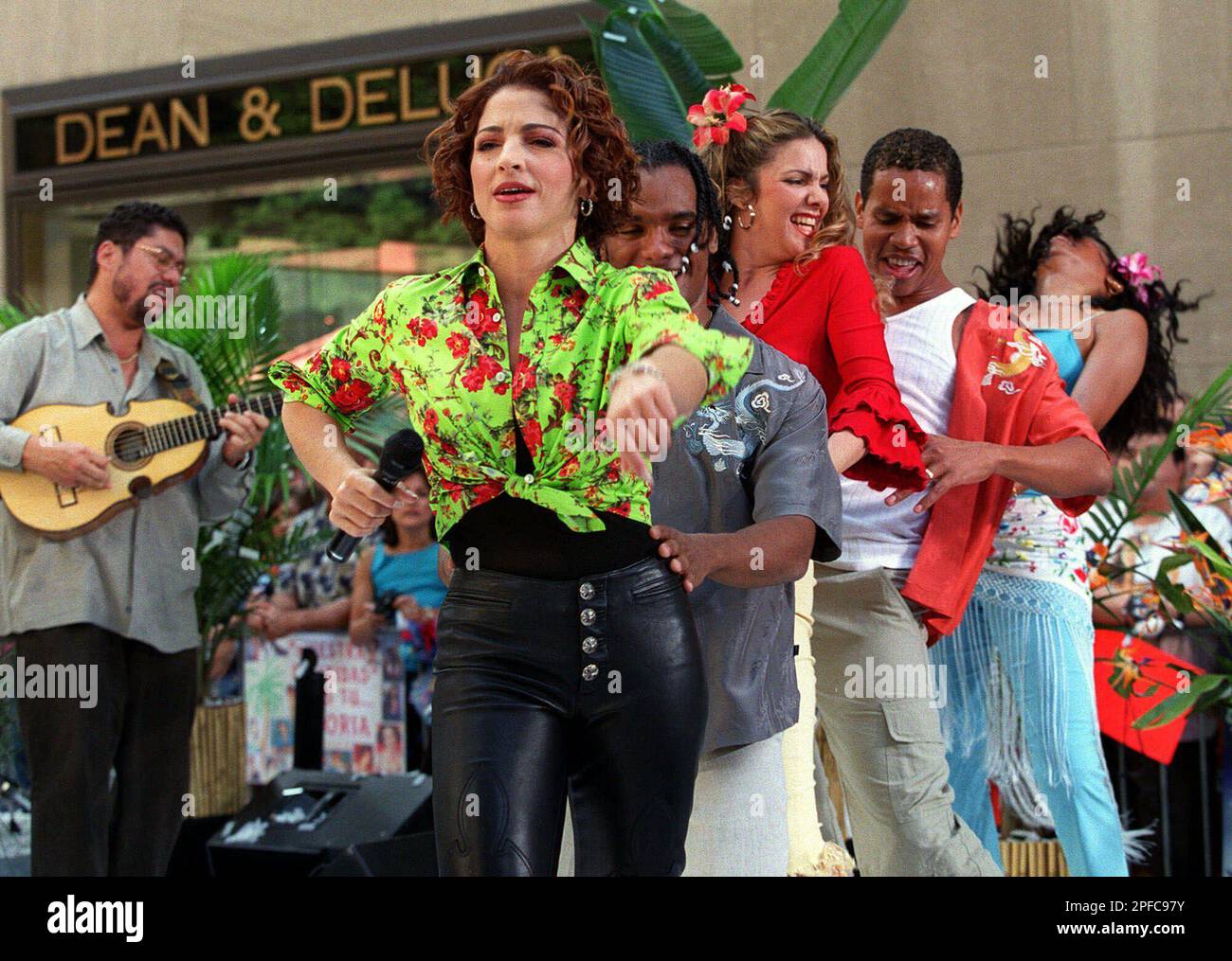 Singer Gloria Estefan leads a conga line during a live performance on