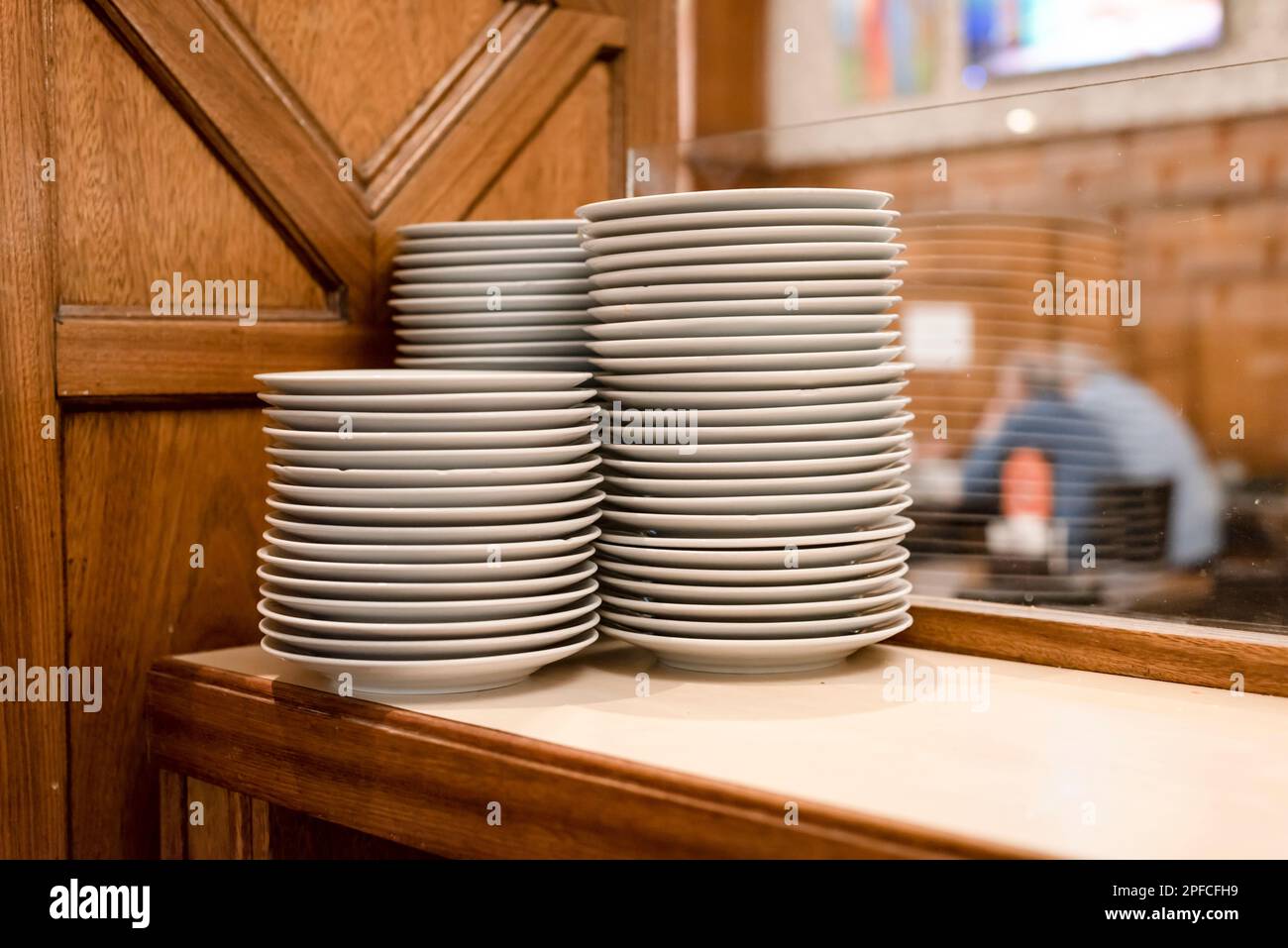 Piles of white dishes in a restaurant Stock Photo