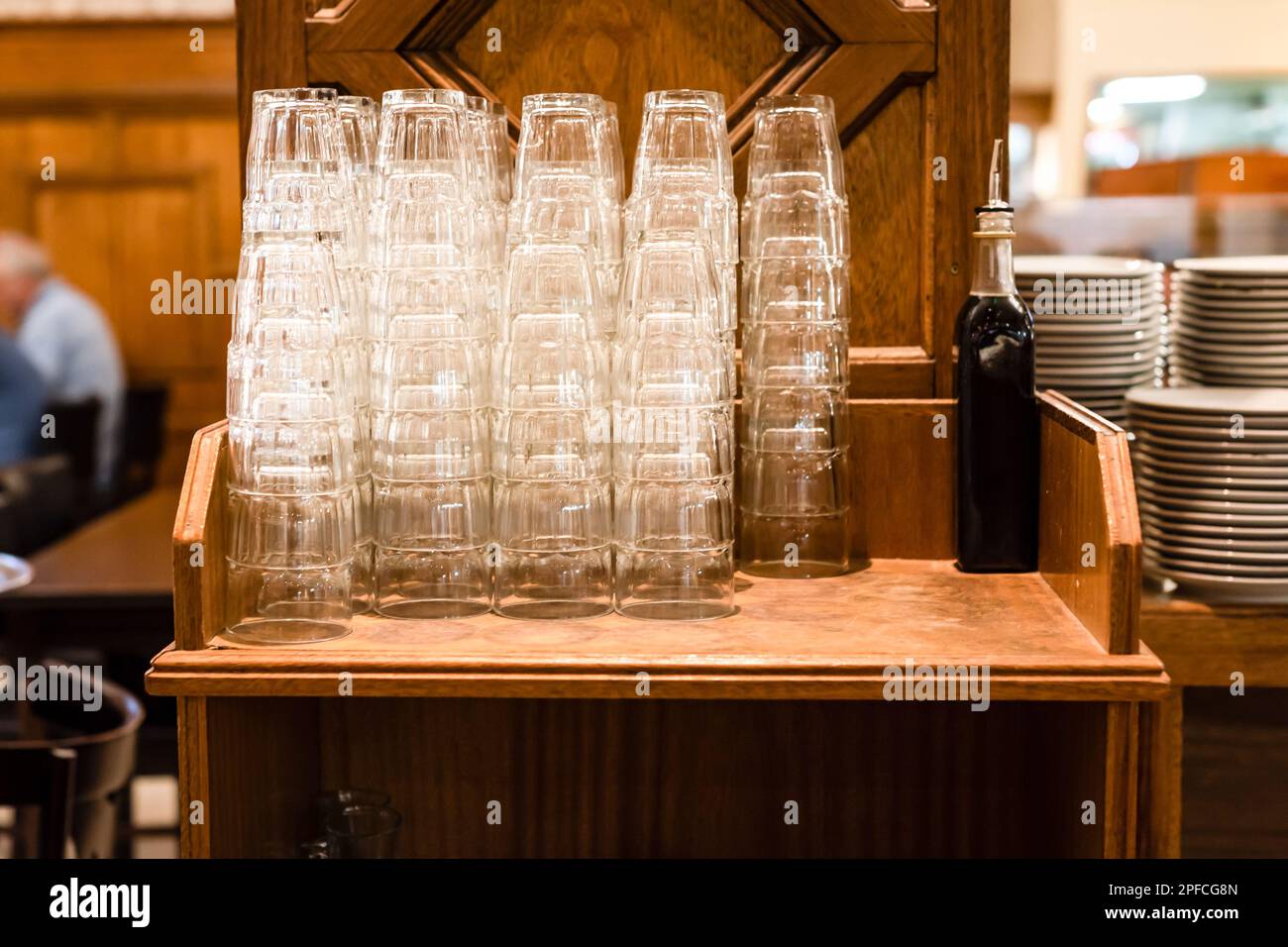 Stacks of clean empty glasses in a restaurant Stock Photo