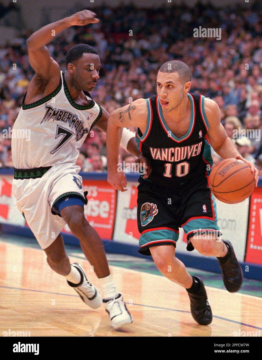 Vancouver Grizzlies guard Mike Bibby, #10, loses the ball after colliding  with Lakers guard Derek Harper on Monday, March 29, 1999 at Inglewood,  California while Harper was trying to gain possession during
