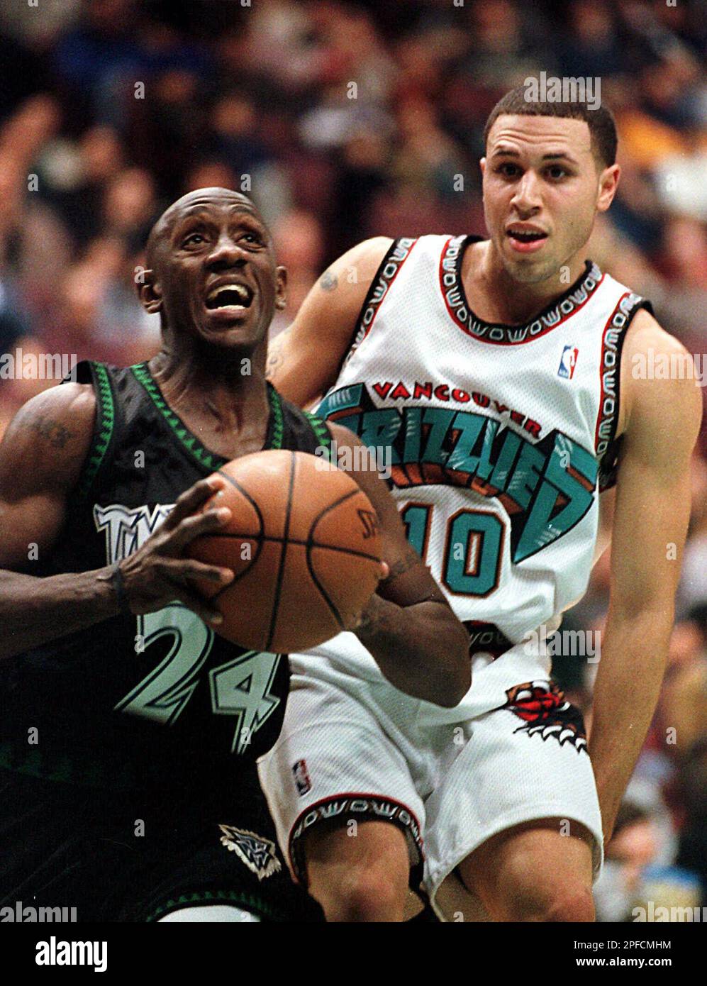 Vancouver Grizzlies guard Mike Bibby, #10, loses the ball after colliding  with Lakers guard Derek Harper on Monday, March 29, 1999 at Inglewood,  California while Harper was trying to gain possession during